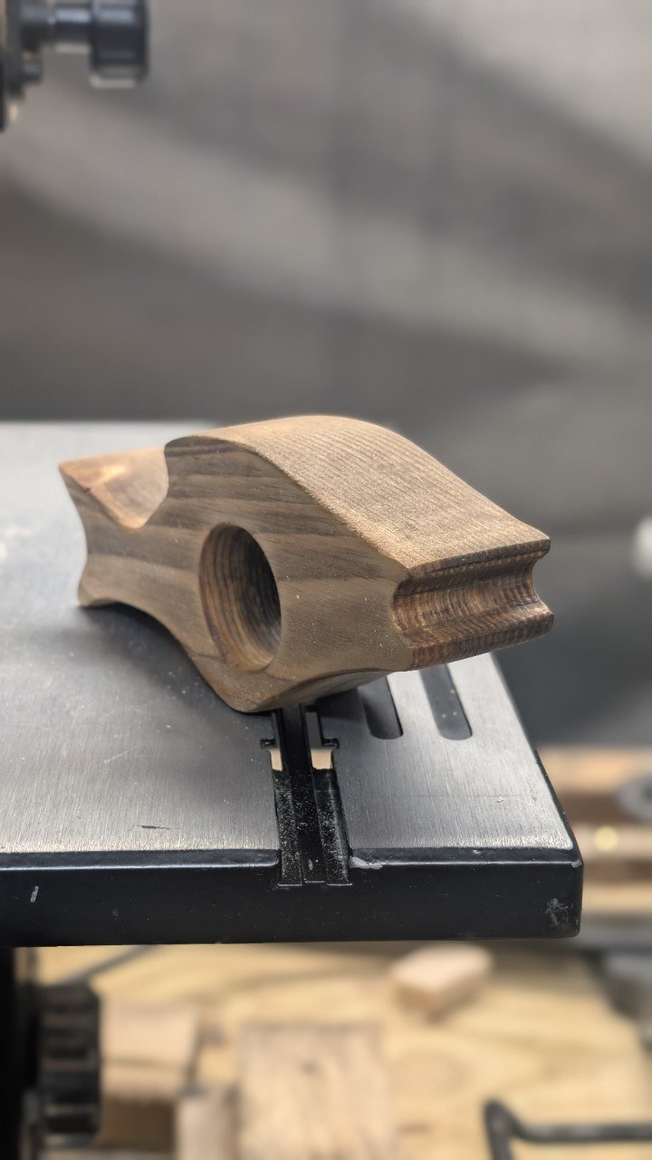 Sculpted thumb page holder in dark hardwood